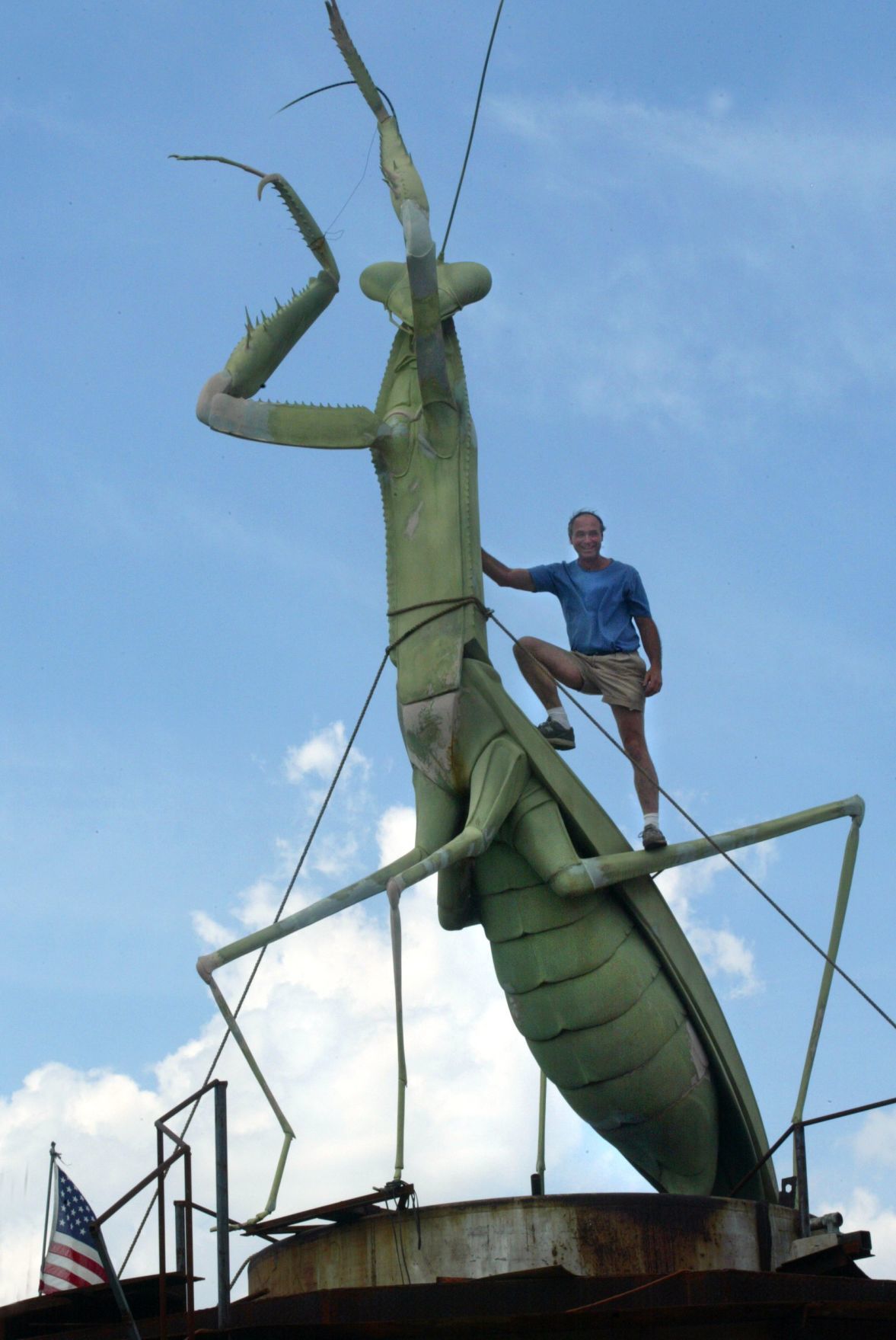 Bob Cassilly poses at his giant prayingmantis at City Museum